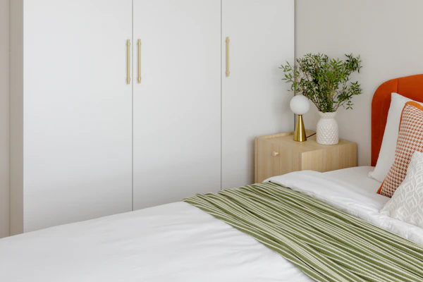 Example photo: white floor-to-ceiling fitted wardrobe doors in a bedroom